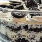 Oreo Dirt Cake – A no-bake dessert with layers of crushed Oreos, pudding, and whipped topping, served in a trifle dish.