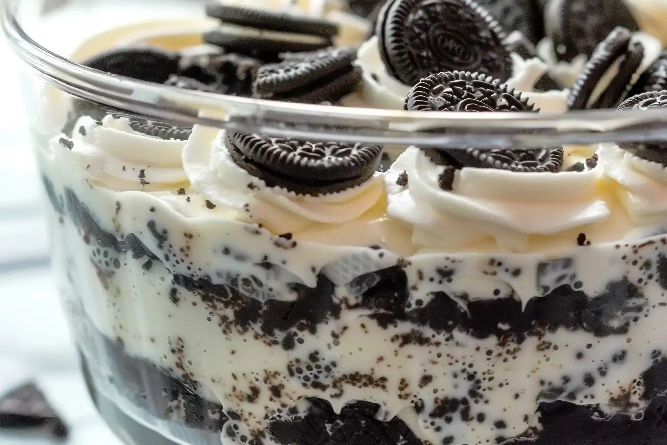 Oreo Dirt Cake – A no-bake dessert with layers of crushed Oreos, pudding, and whipped topping, served in a trifle dish.